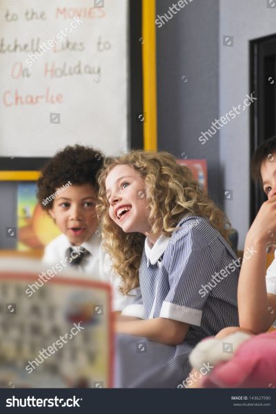 stock-photo-cheerful-elementary-schoolgirl-with-boys-sitting-in-classroom-143627590